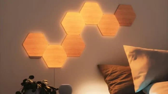 Nanoleaf Elements Hexagon-Paneele in Holzoptik mit warmem Licht als stimmungsvolle Wanddekoration.